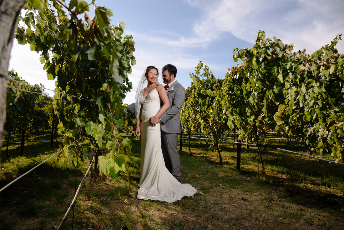 dancing apache ranch first look in vineyard with bride and groom portrait