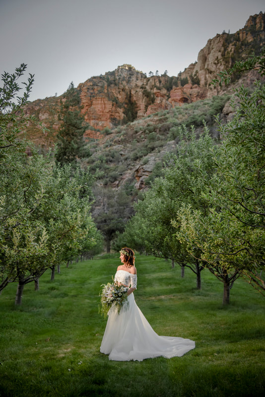 Orchard Canyon wedding in Sedona bride portrait in apple trees boho chic | flower crown