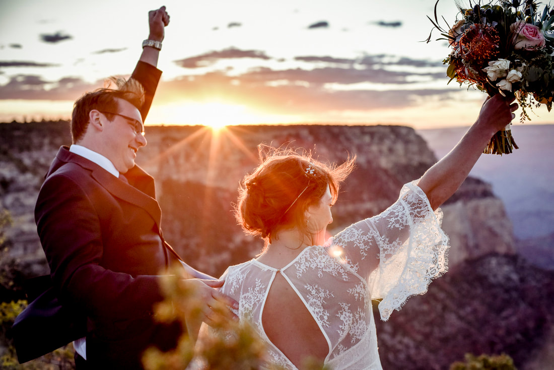 happy bride and groom cheering at sunset grand canyon national park wedding 