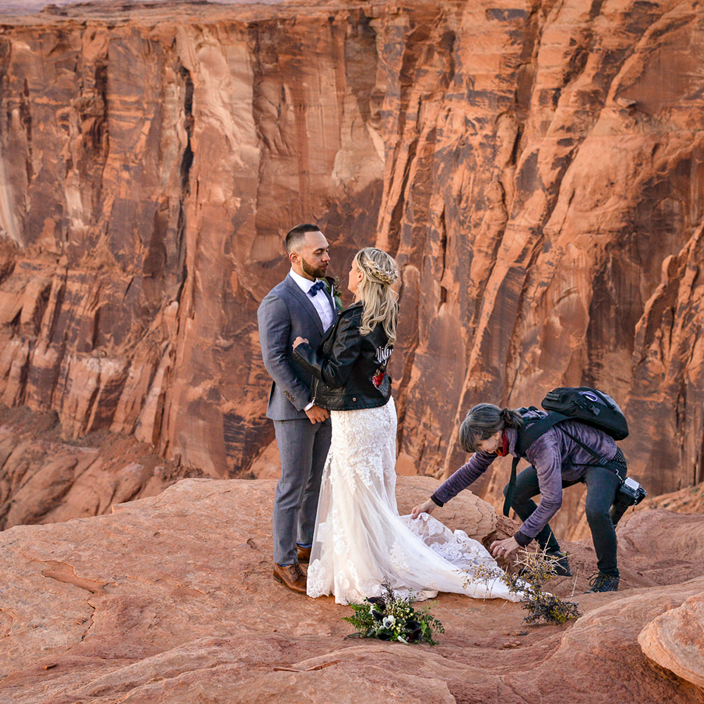 horseshoe bend slot canyon tour private destination adventure wedding photographer helping bride with dress